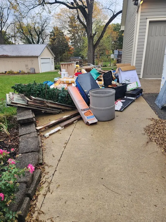 Dumpster being loaded with debris for 3 Yard Dumpster Rental in Kawkawlin